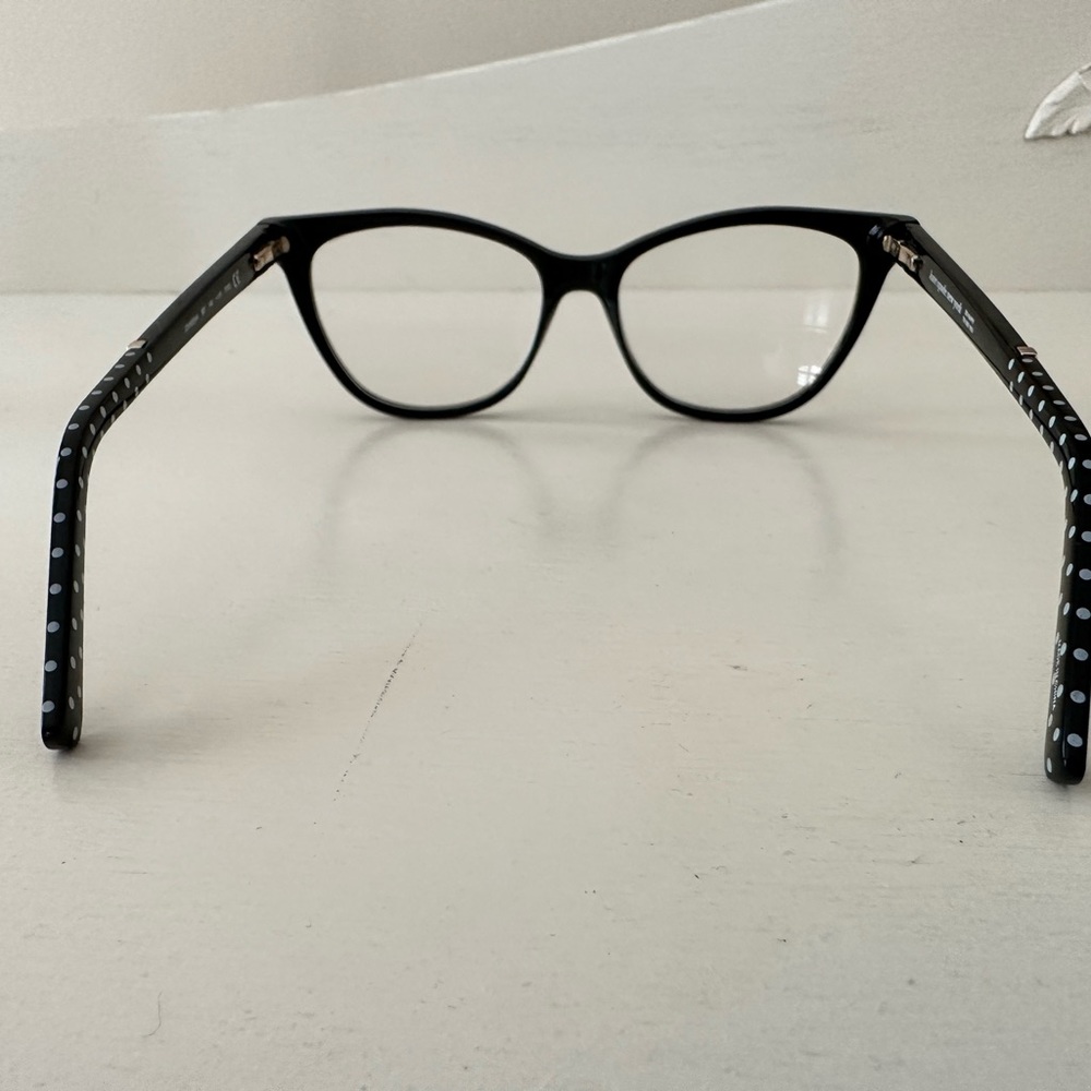 Kate Spade eyeglasses. Black with white dots on the sides.